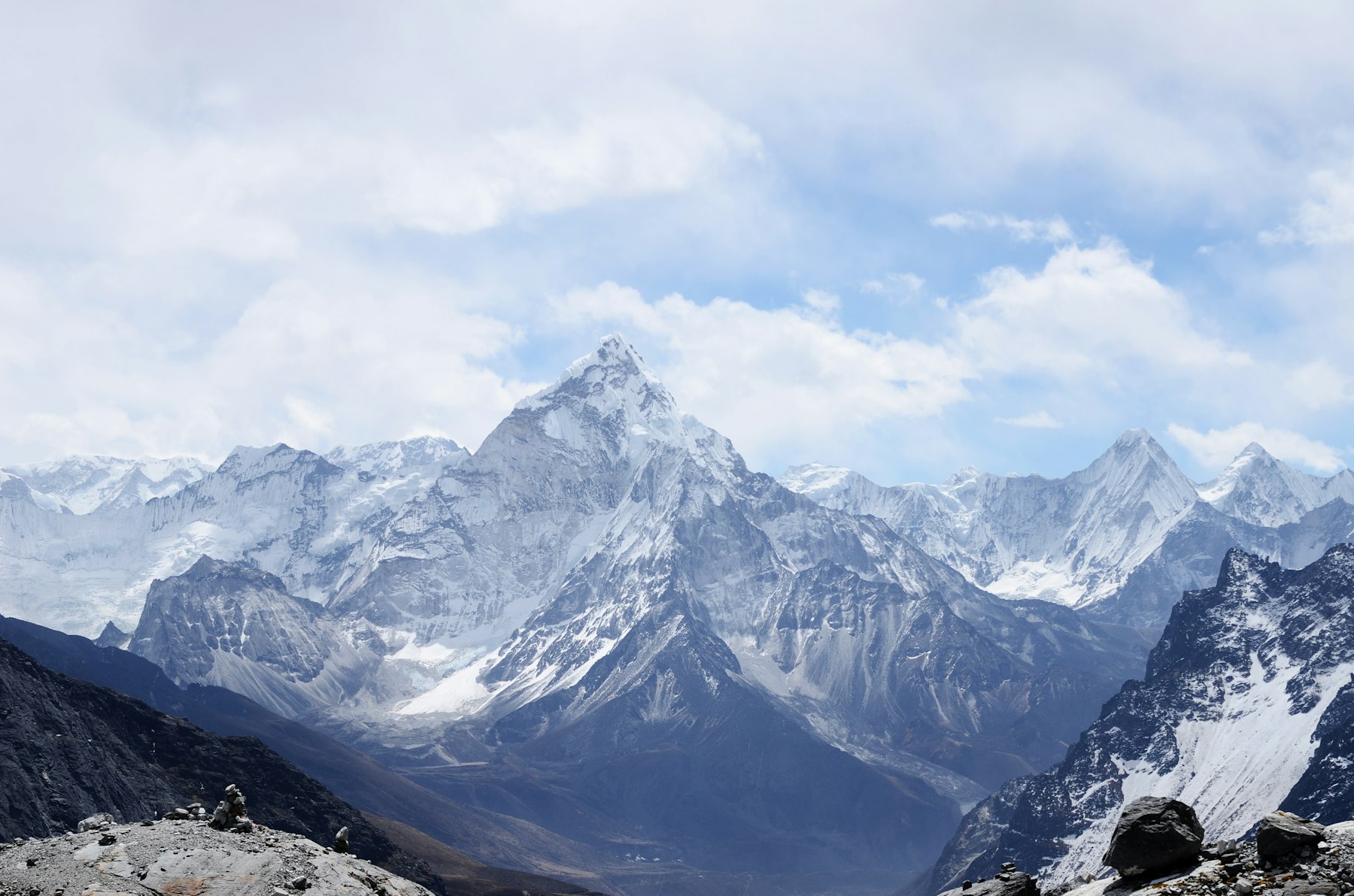 Snow-covered alpine peaks under a clearing sky
